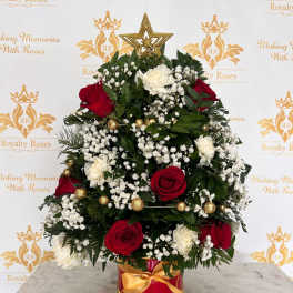 Red and white rose arrangement in a gold-trimmed red box with a star topper