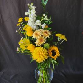 Yellow and white mixed bouquet in a clear glass vase