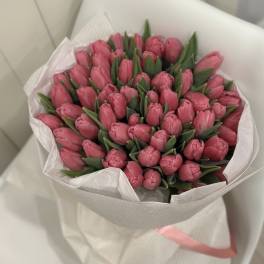 Bouquet of pink tulips wrapped in white paper