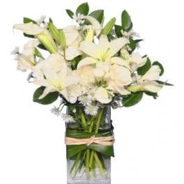White lilies and roses in a clear rectangular vase