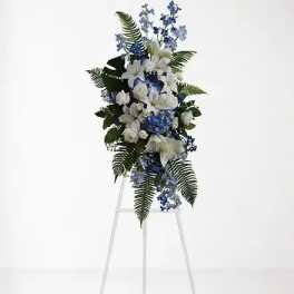 White and blue floral standing spray on a metal easel
