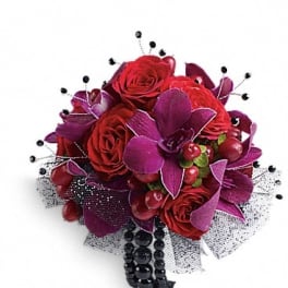 Bouquet of red roses with purple accents and black bead strands