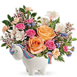 Bouquet of roses and small flowers in a unicorn-shaped vase
