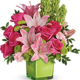 Pink lilies and roses in a green square vase
