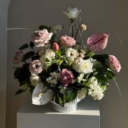 Pink and white floral arrangement in a white vase