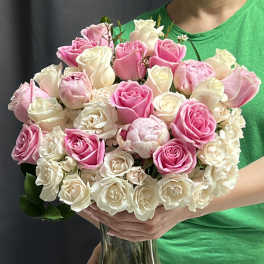 Bouquet of pink and white roses in a clear glass vase