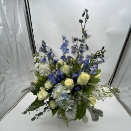 Blue and white floral arrangement in a clear glass vase
