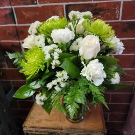Bouquet of white roses and green chrysanthemums in a glass vase