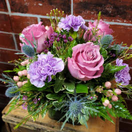 Pink and lavender bouquet with roses and carnations in a vase