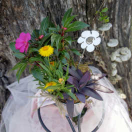 Small potted floral arrangement with pink and yellow blooms