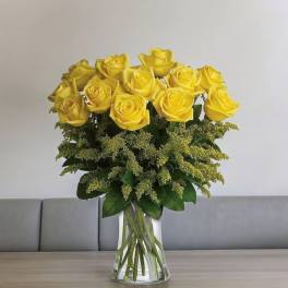 Yellow roses arranged in a clear glass vase
