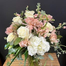 Bouquet of blush and white flowers in a glass vase