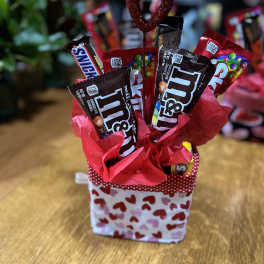 Heart-themed candy gift basket with M&M's and Snickers bars