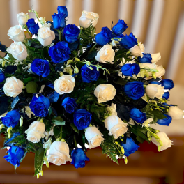 Bouquet of blue and white roses in a dense rounded arrangement
