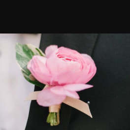 Pink boutonniere with a ribbon tie
