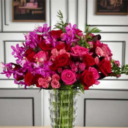 Pink and red rose bouquet in a clear glass vase
