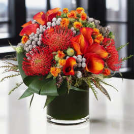 Bouquet of red-orange flowers in a glass vase