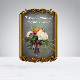 Bouquet of white and pink flowers in an ornate gold frame