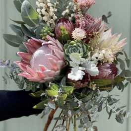 Hand-tied bouquet with pink protea and succulents