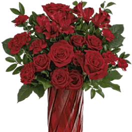 Red roses and carnations in a tall red glass vase