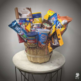 Basket of assorted snack packages and candy on a table