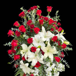 Red roses and white lilies arranged in a large bouquet