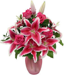 Pink roses and stargazer lilies in a pink vase