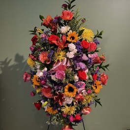 Large colorful standing floral spray on an easel