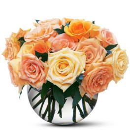 Bouquet of peach and yellow roses in a round glass vase