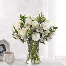 White floral bouquet in a clear glass vase
