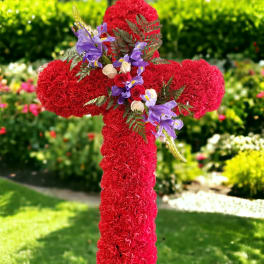 Red floral cross on a stake with purple and white accents