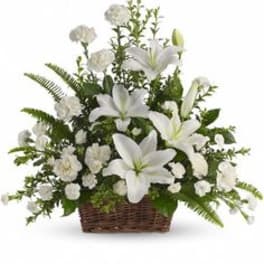 White lilies and carnations in a wicker basket