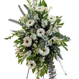 White gerbera daisy standing spray with mixed greenery