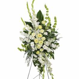 Tall white and green standing funeral spray on a metal easel