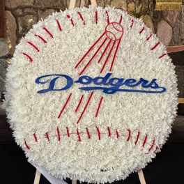 Round white floral tribute shaped like a baseball with Dodgers lettering