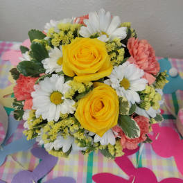 Bouquet of yellow roses, white daisies, and pink carnations