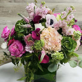 Pink and white mixed bouquet in a square glass vase