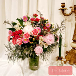 Mixed pink and white flower arrangement in a glass vase
