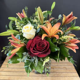 Bouquet of roses and lilies in a glass vase