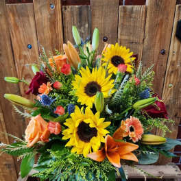 Bouquet of sunflowers, orange lilies, and roses