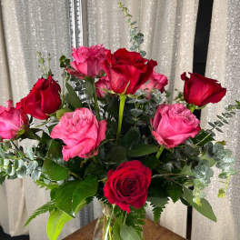 Bouquet of red and pink roses in a clear glass vase