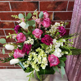 Pink and white rose bouquet in a glass vase