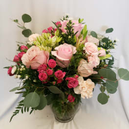 Pink and cream rose bouquet in a glass vase