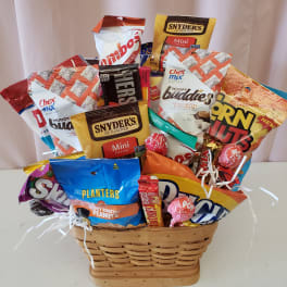 Basket of assorted snack bags and candy on a table