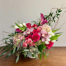 Pink and white floral arrangement in a white vase