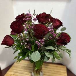Bouquet of dark red roses in a glass vase