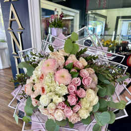 Large bouquet of pink and cream roses with eucalyptus
