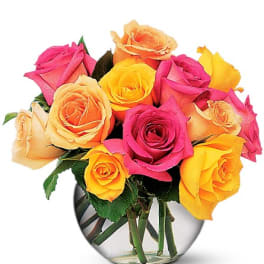 Bouquet of multicolored roses in a clear glass vase