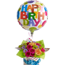 Birthday balloon above a rose bouquet in a polka-dot gift box