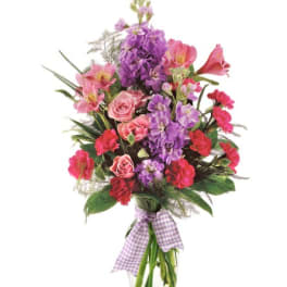 Pink and purple mixed bouquet in a glass vase with a gingham ribbon